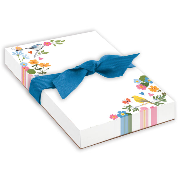 A thick notepad with a floral design and a blue ribbon on the cover, titled 'Chunky Bow Pad - Songbirds and Flowers'.