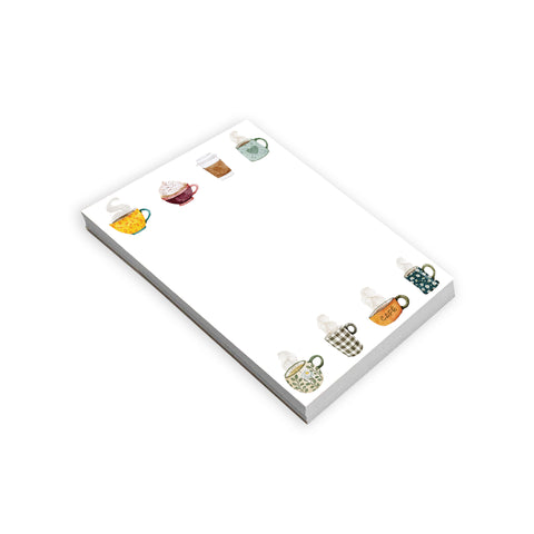 Notepad with coffee cups on a white background